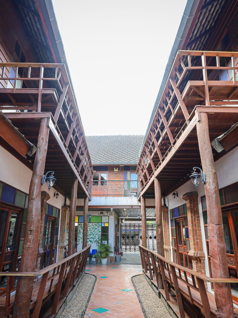 Symmetrical walkway between Lanna-style teak buildings at Jintara Rehab Chiang Mai Thailand
