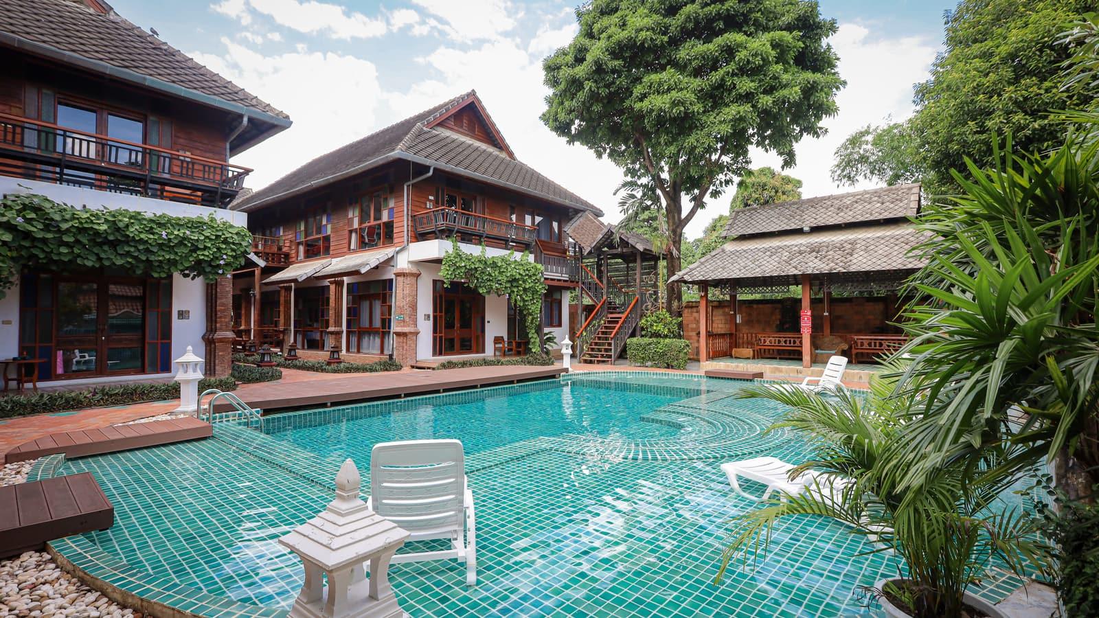 Pool and Lanna-style teak buildings at the licensed Jintara Rehab facility in Chiang Mai Thailand