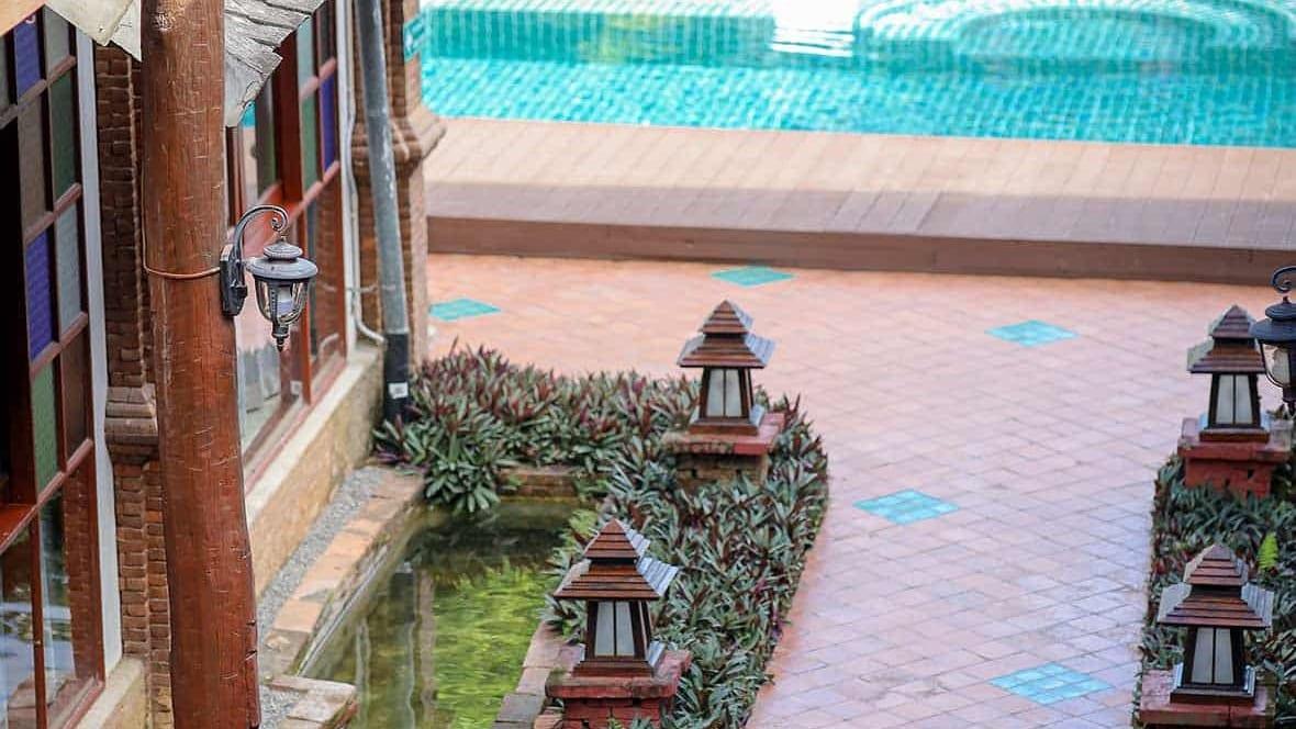 Pool terrace and garden walkway with Lanna lanterns at Jintara Rehab in Chiang Mai