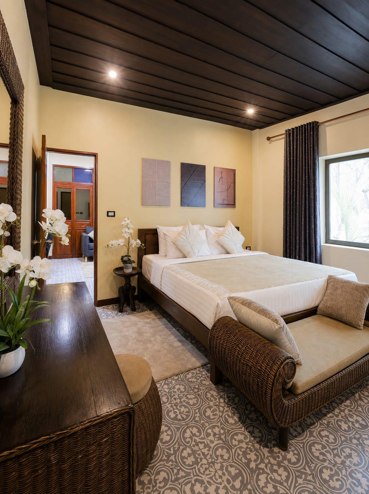 Private bedroom with king bed and Lanna-style teak ceiling at Jintara Rehab Chiang Mai