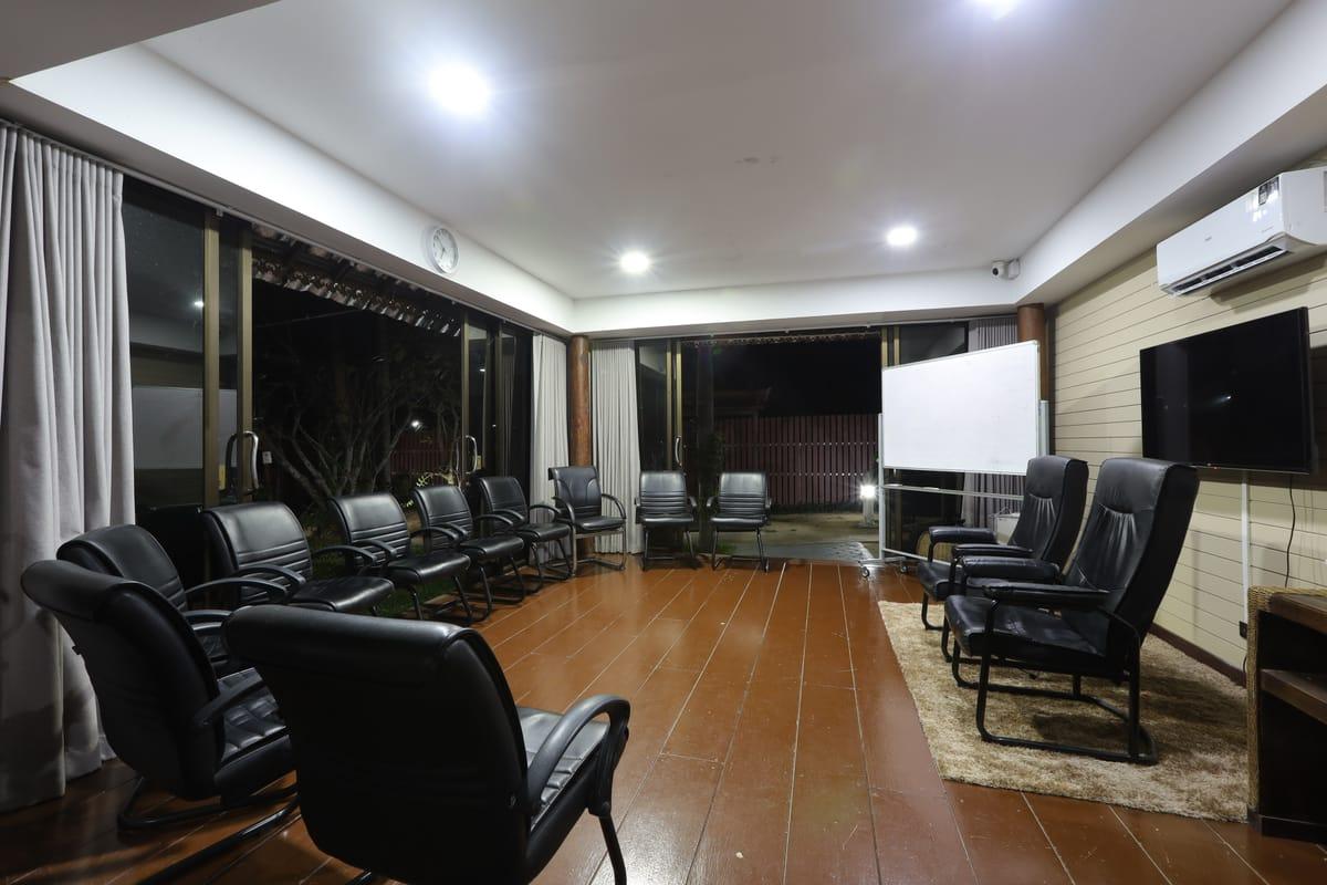 Group therapy room at Jintara Rehab in Chiang Mai with leather armchairs arranged in a circle