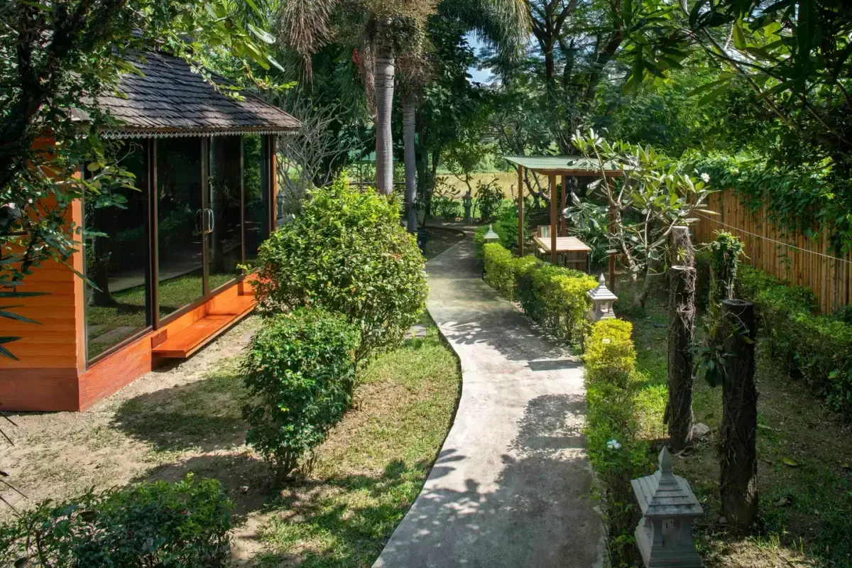 Garden pathway and grounds at Jintara Rehab where structured daily programming takes place in Chiang Mai