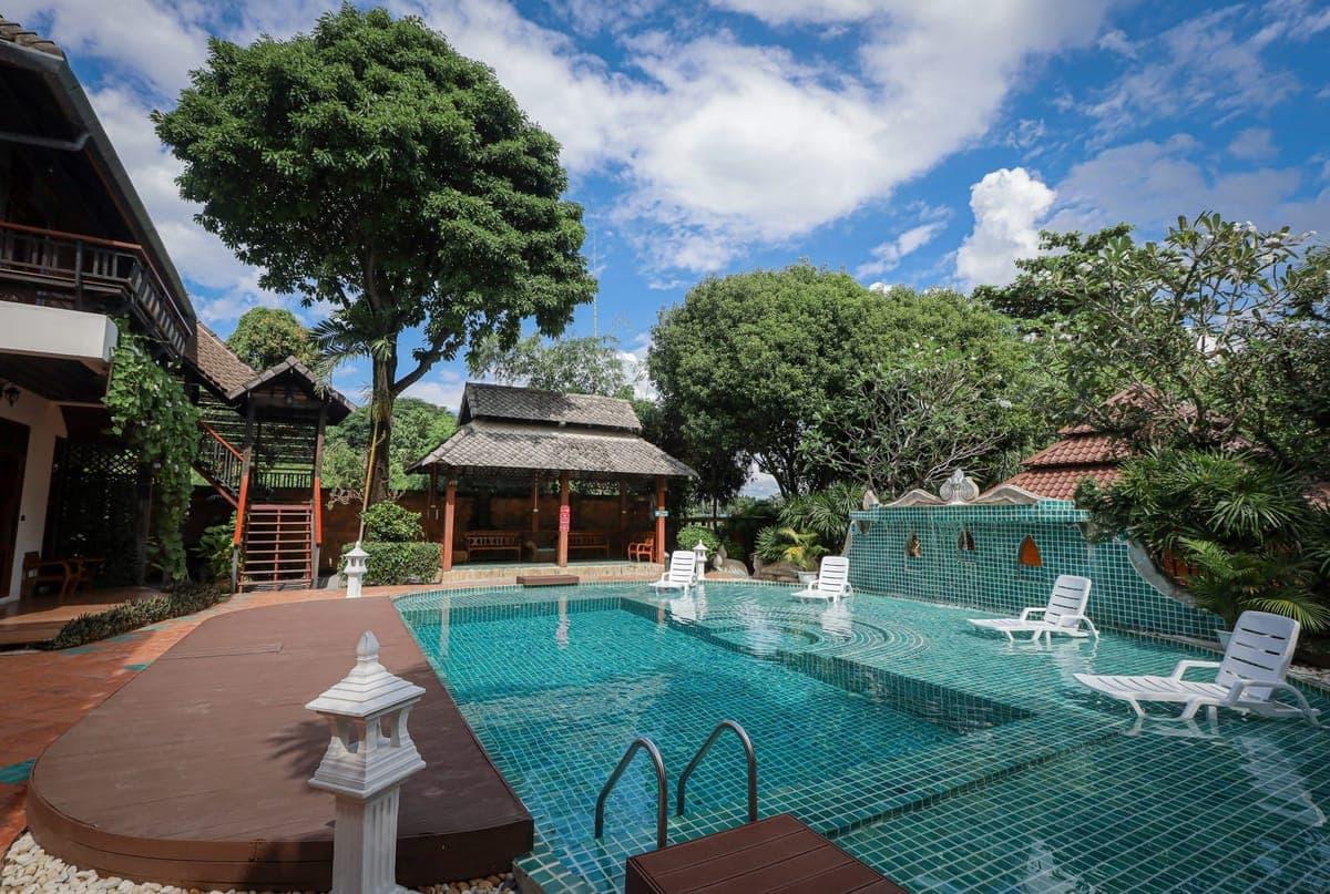 Teal mosaic pool and Thai sala in bright daytime calm residential setting for post-taper anxiety at Jintara Rehab