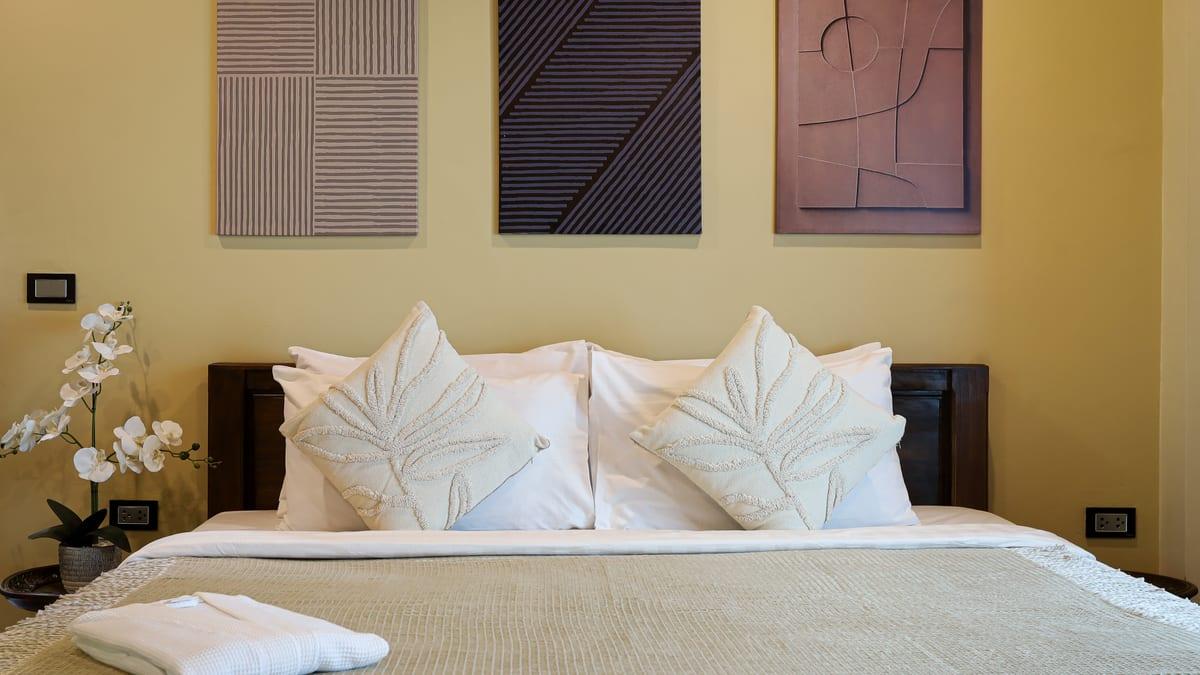 Warm private bedroom with soft lighting and framed art at Jintara Rehab Chiang Mai Thailand