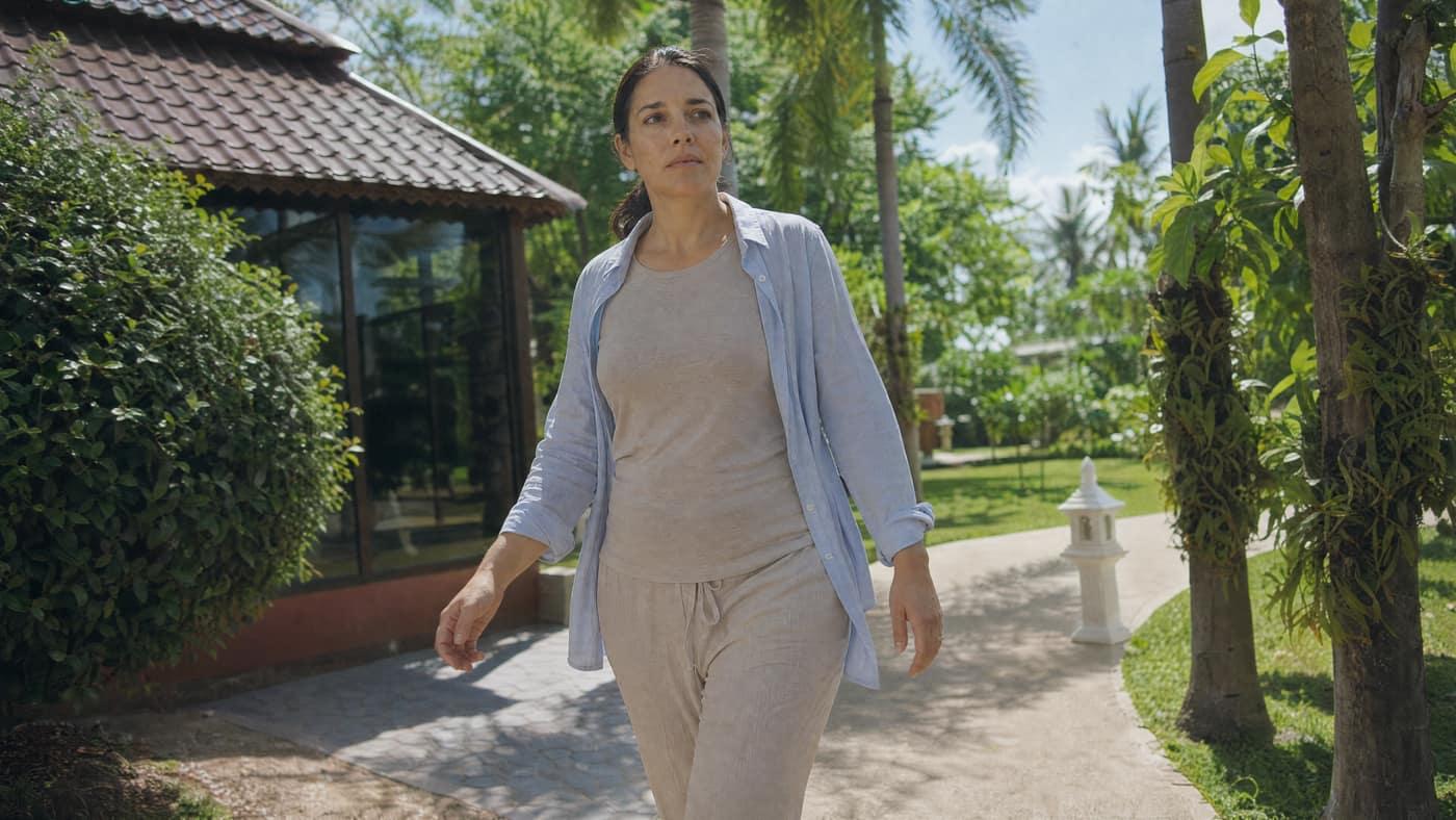 Person walking the garden grounds at Jintara Rehab Chiang Mai during recovery from cough syrup dependence