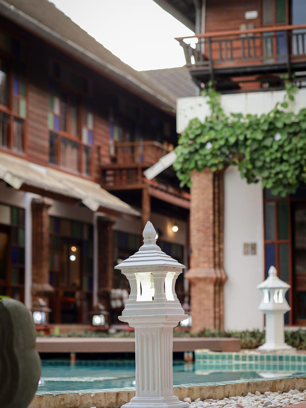 Teak courtyard and lantern-lined pool terrace at Jintara Rehab in Chiang Mai on arrival day