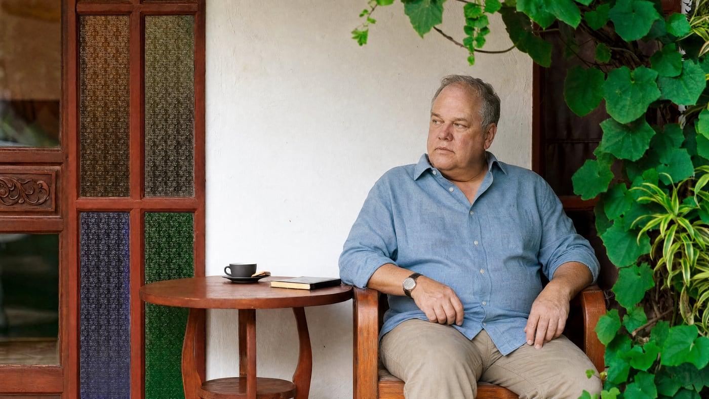 Man sitting calmly on a Jintara veranda in Chiang Mai where bipolar disorder and addiction are treated together