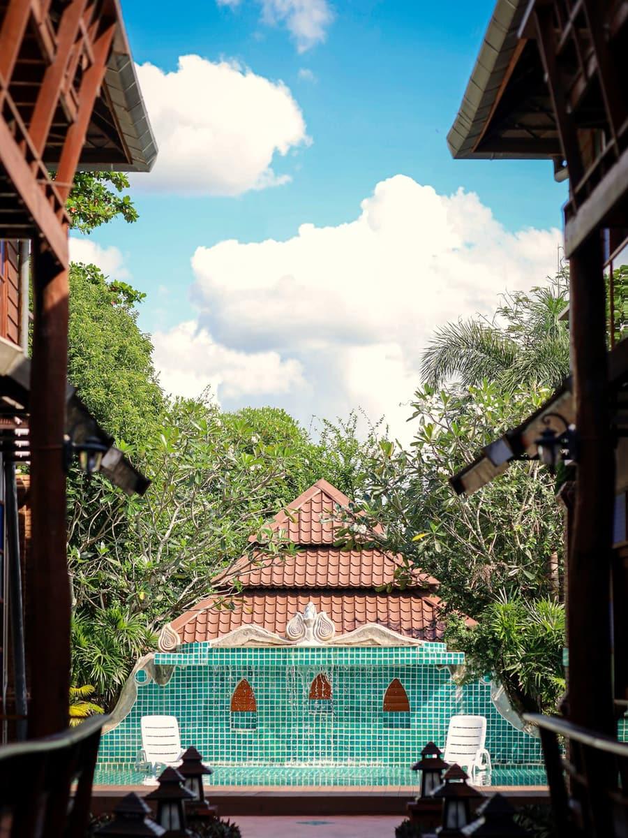 Covered brick walkway between Lanna buildings at Jintara Rehab in Chiang Mai, Thailand