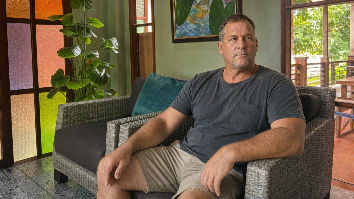 A man sitting calmly in a lounge armchair at Jintara Rehab in Chiang Mai during recovery