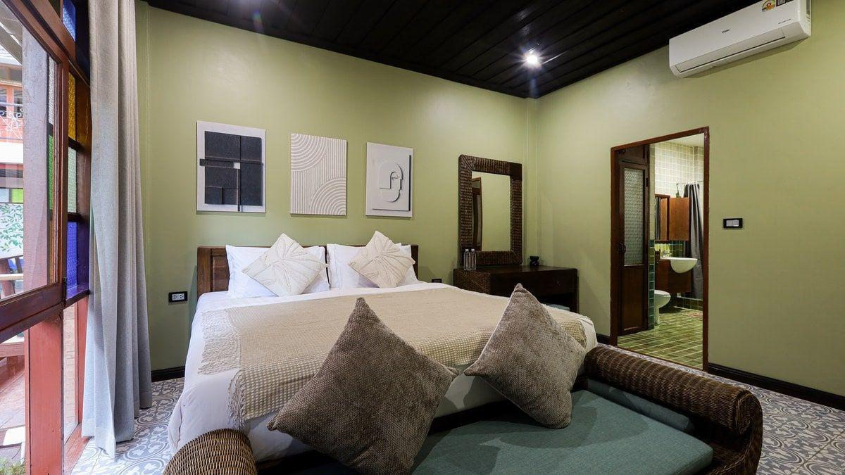 Calm private bedroom with a daybed and soft daylight at Jintara Rehab in Chiang Mai