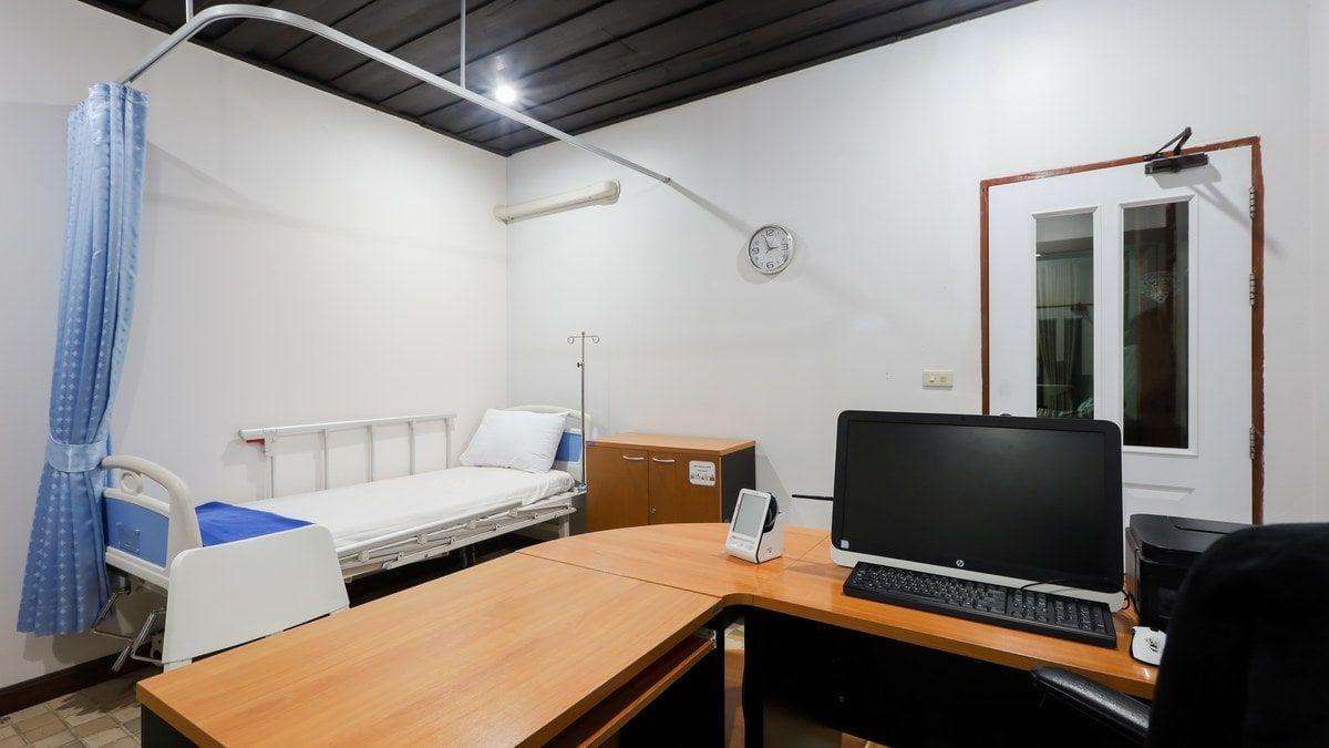 On-site medical room with a nursing bed and monitoring desk at Jintara Rehab in Chiang Mai