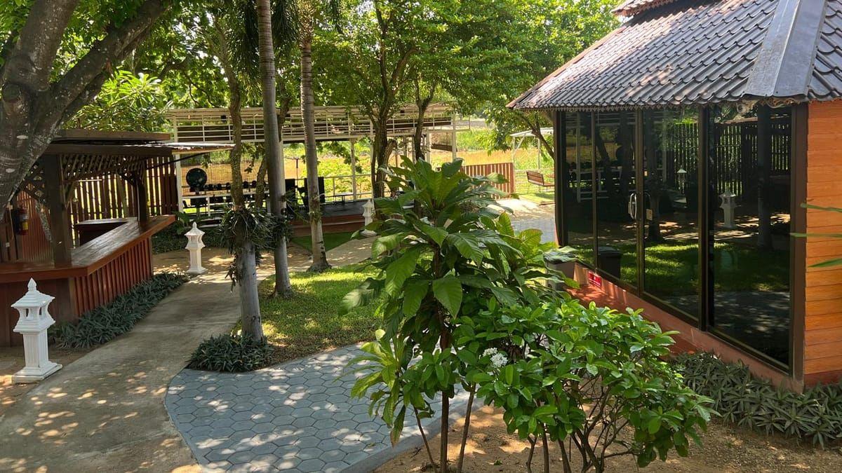 Garden pavilion and tropical planting on the grounds of Jintara Rehab in Chiang Mai