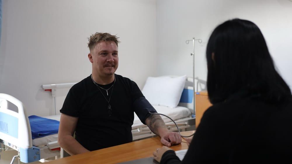 Patient receiving blood pressure check in Jintara Rehab medical room during gabapentin opioid detox