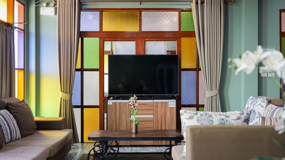 Bright communal lounge with colourful stained glass panels at Jintara Rehab Chiang Mai after detox recovery space