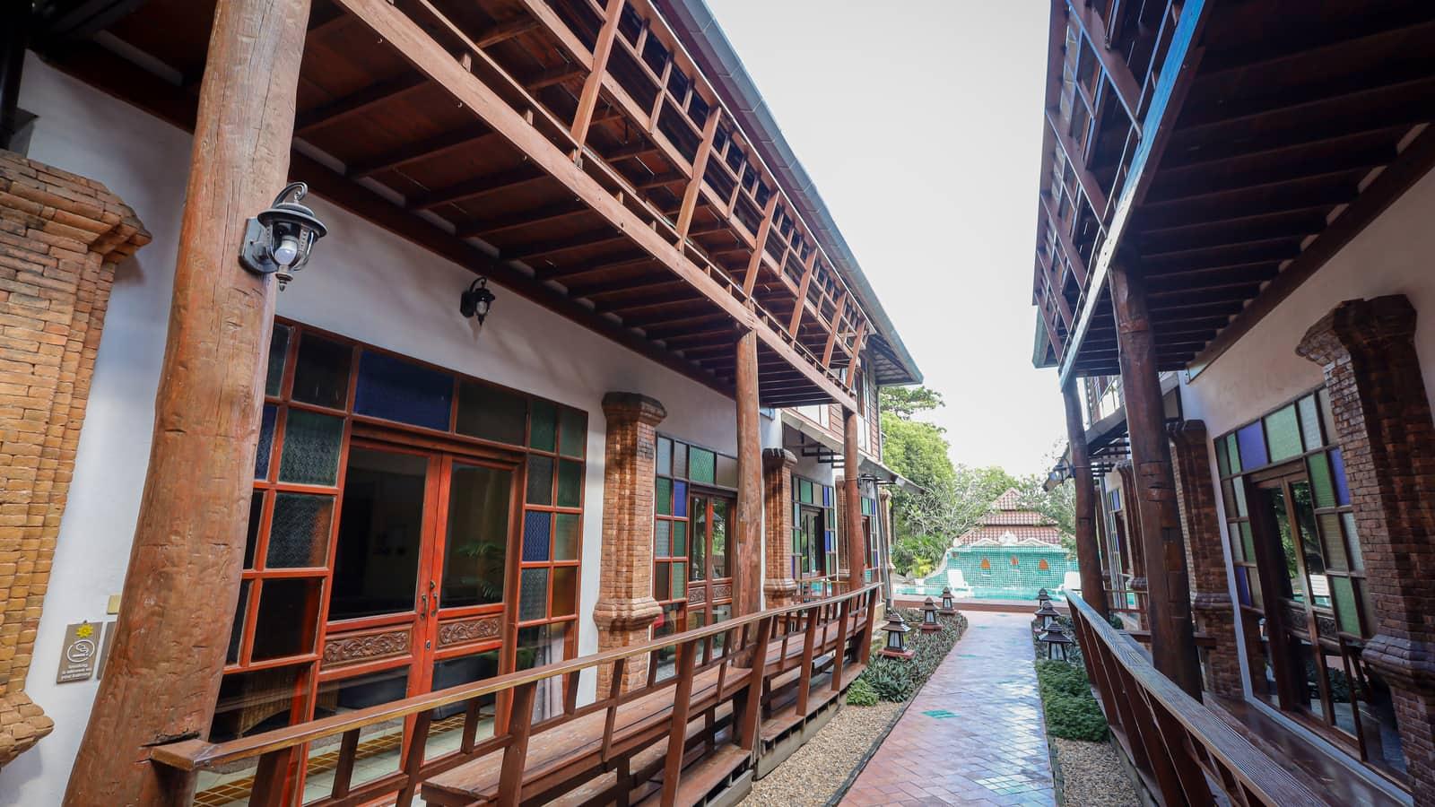 Stone lantern-lined walkway through tropical gardens at Jintara Rehab Chiang Mai residential