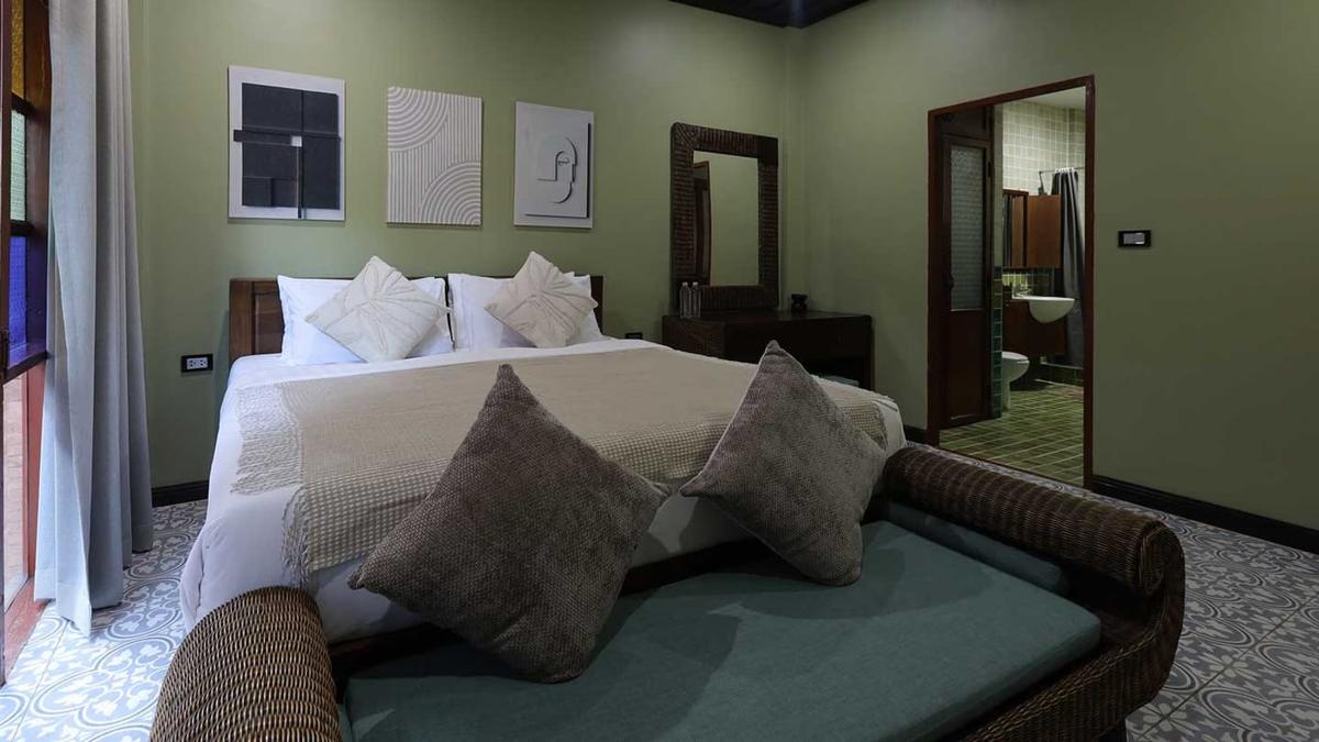 Private bedroom with en-suite bathroom and tiled floor at a residential rehab in Chiang Mai