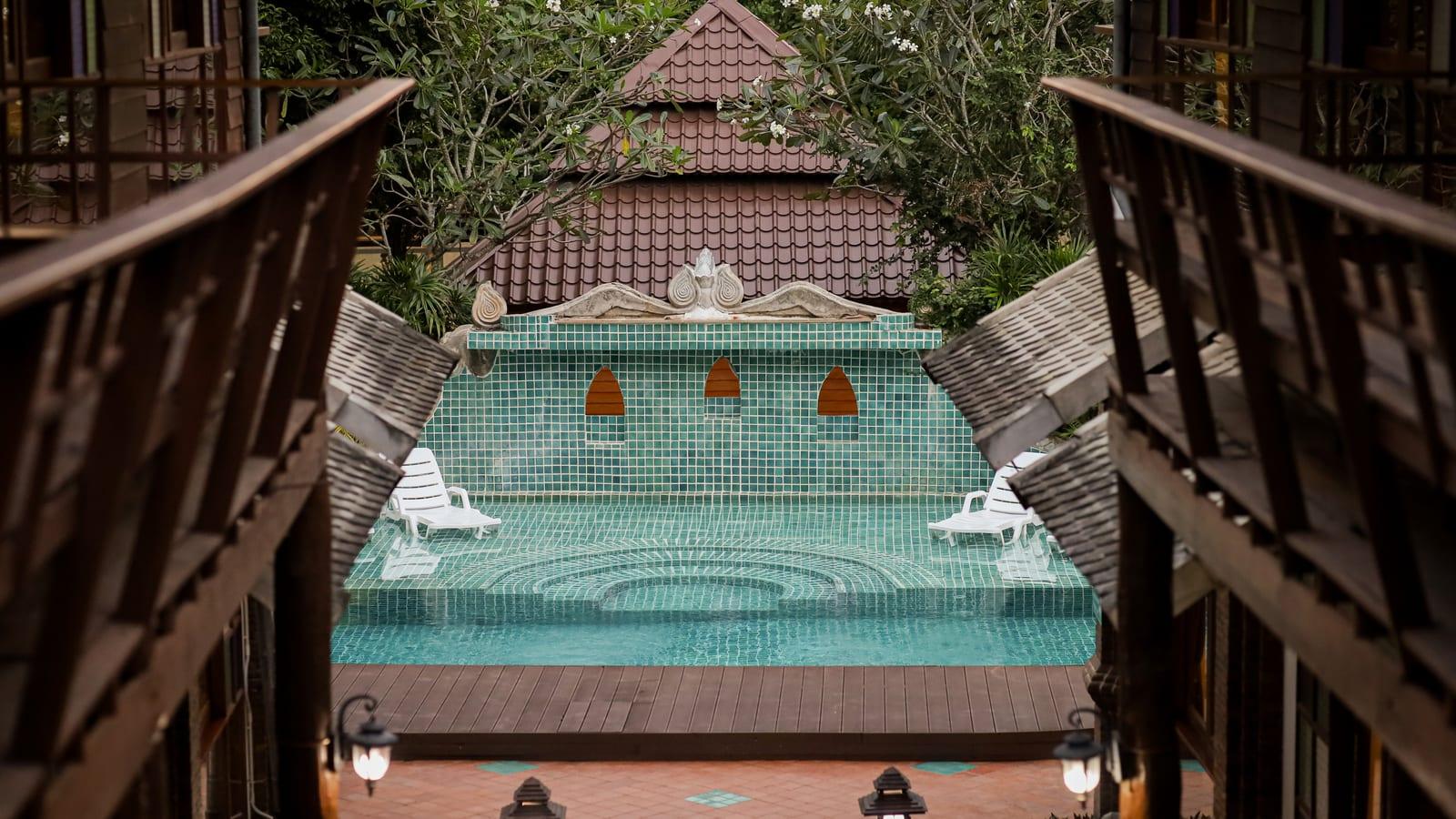 Teal mosaic pool and terracotta courtyard at Jintara Rehab Chiang Mai in daylight