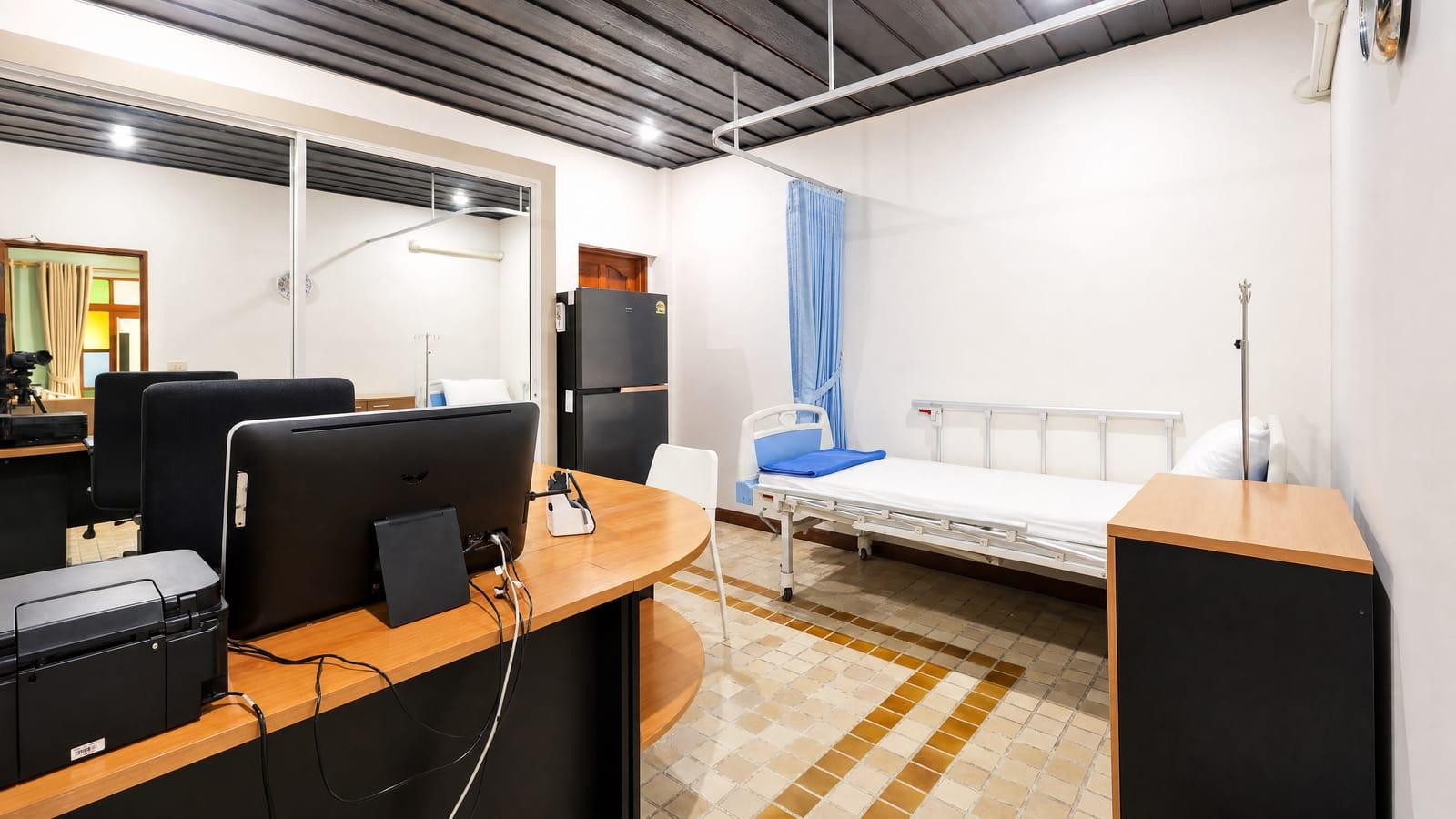 Medical nursing station and consultation desk at Jintara Rehab Chiang Mai Thailand with computers and clinical bed for supervised detox monitoring