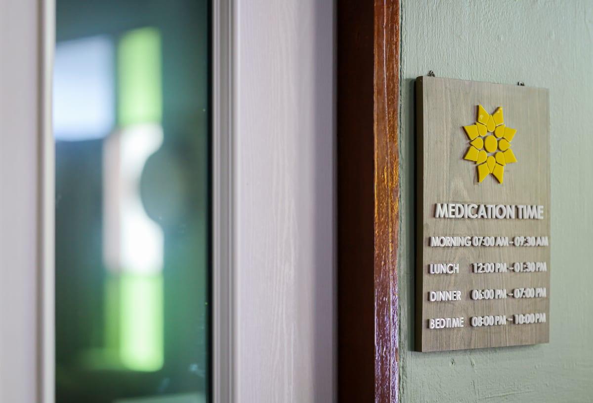 Jintara Rehab medication time schedule sign showing daily medication windows at Chiang Mai Thailand
