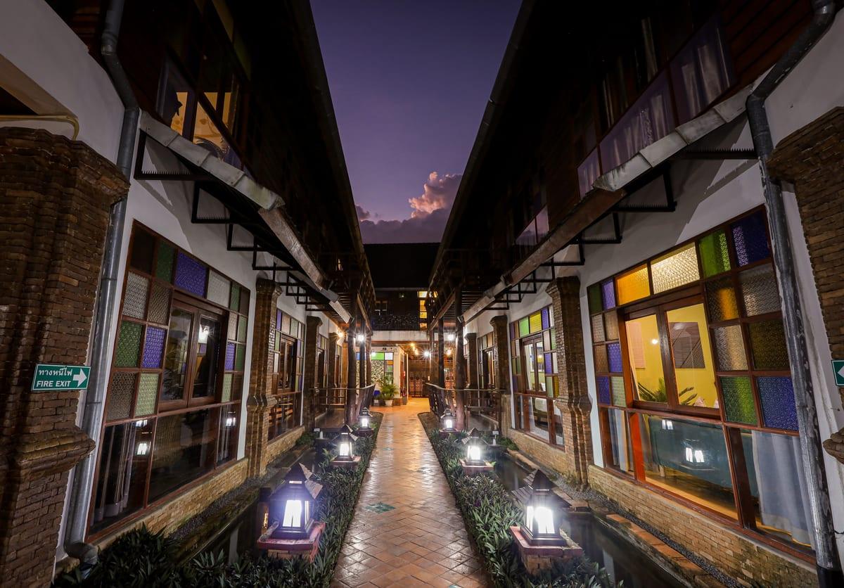 Lantern-lit walkway through Jintara Rehab grounds Chiang Mai residential addiction treatment facility