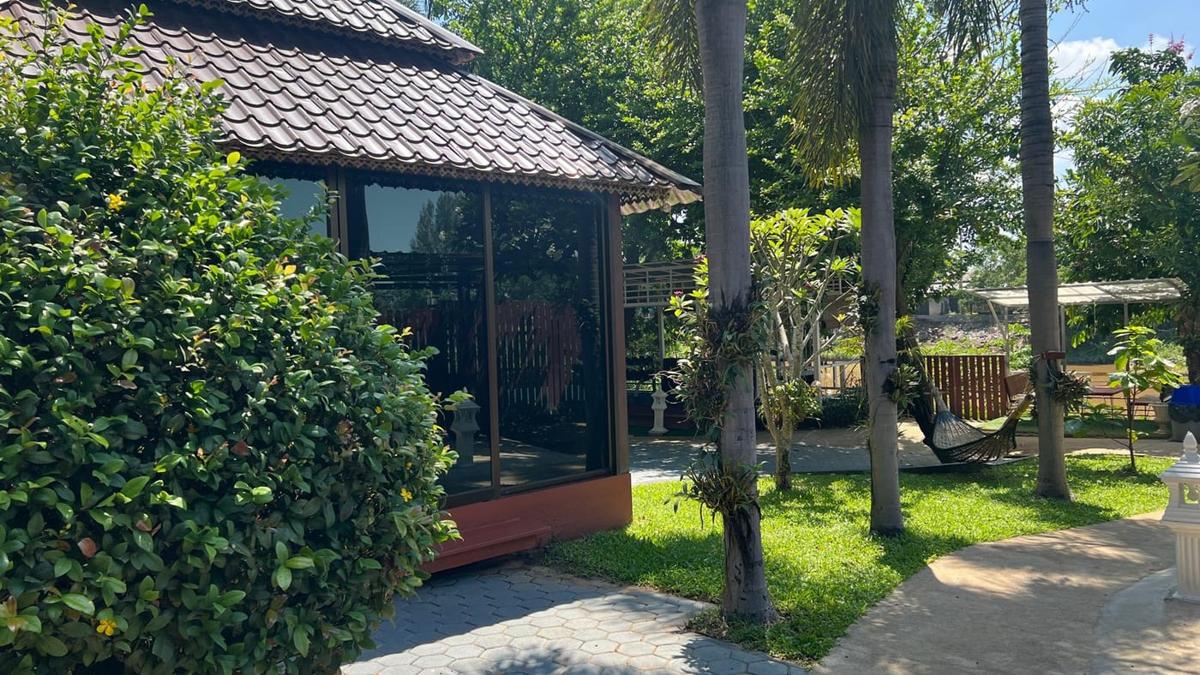 Quiet garden pavilion and palm grounds at Jintara Rehab Chiang Mai Thailand