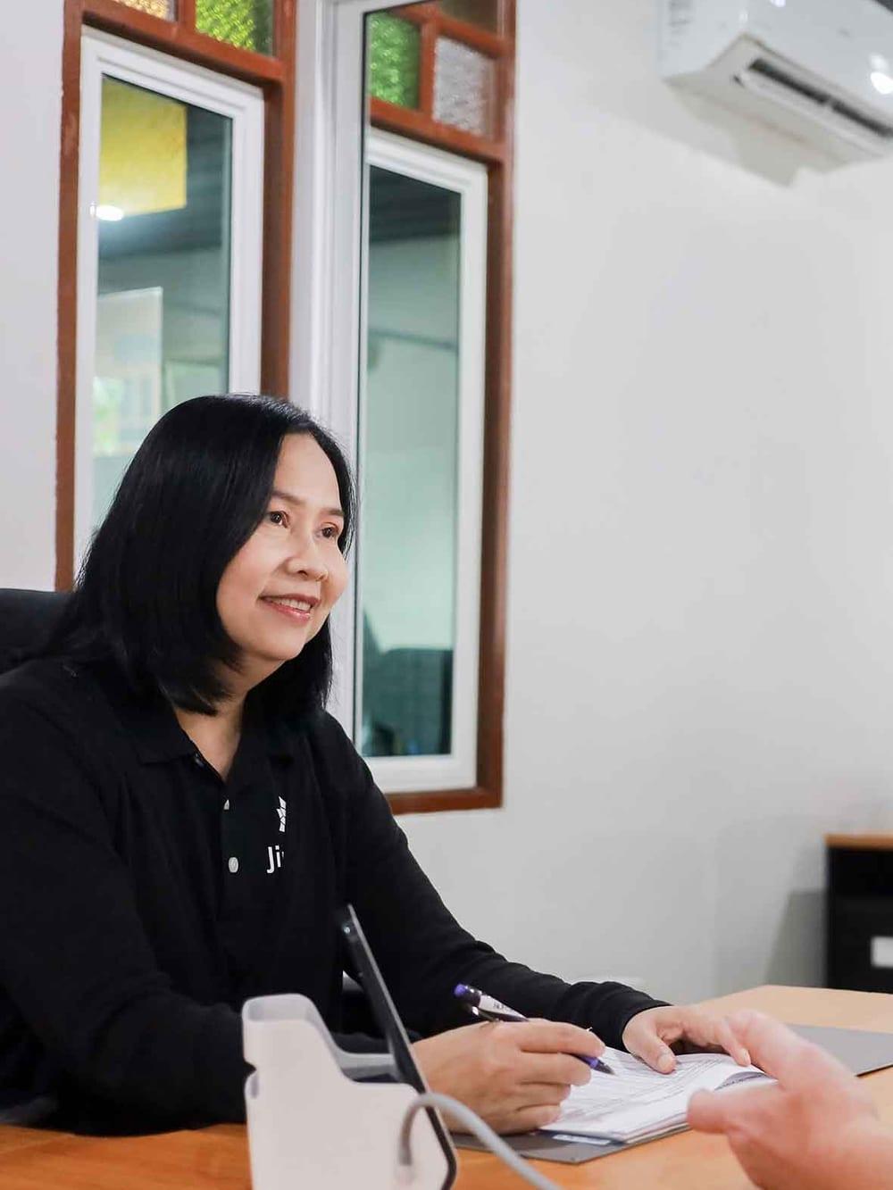 Jintara nursing staff recording a client's observations during the admission assessment in Chiang Mai