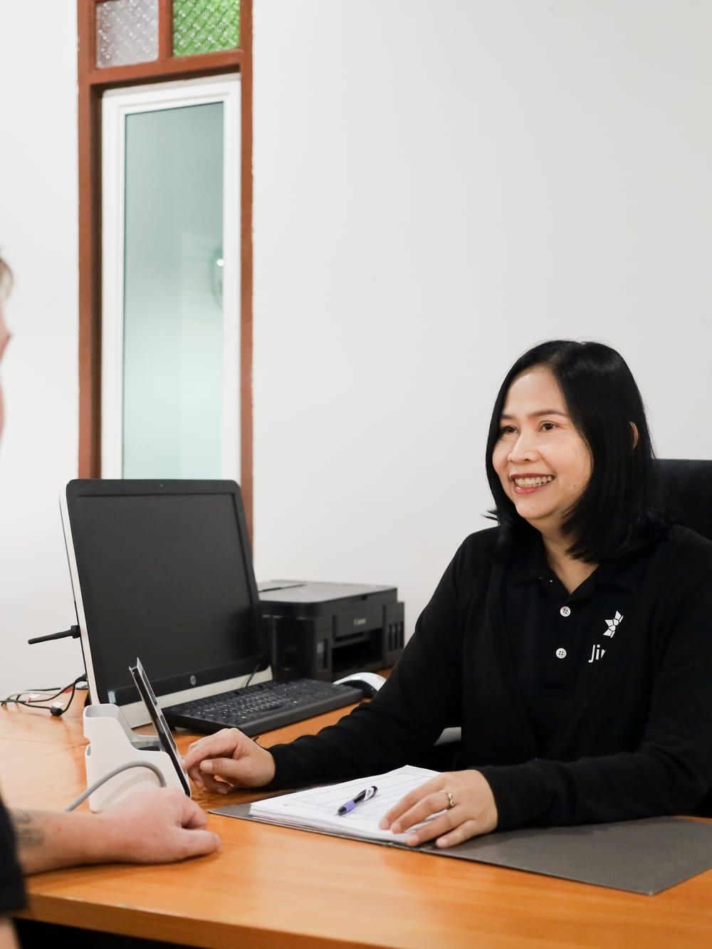 Nurse reviewing intake paperwork with a client at Jintara Rehab Chiang Mai